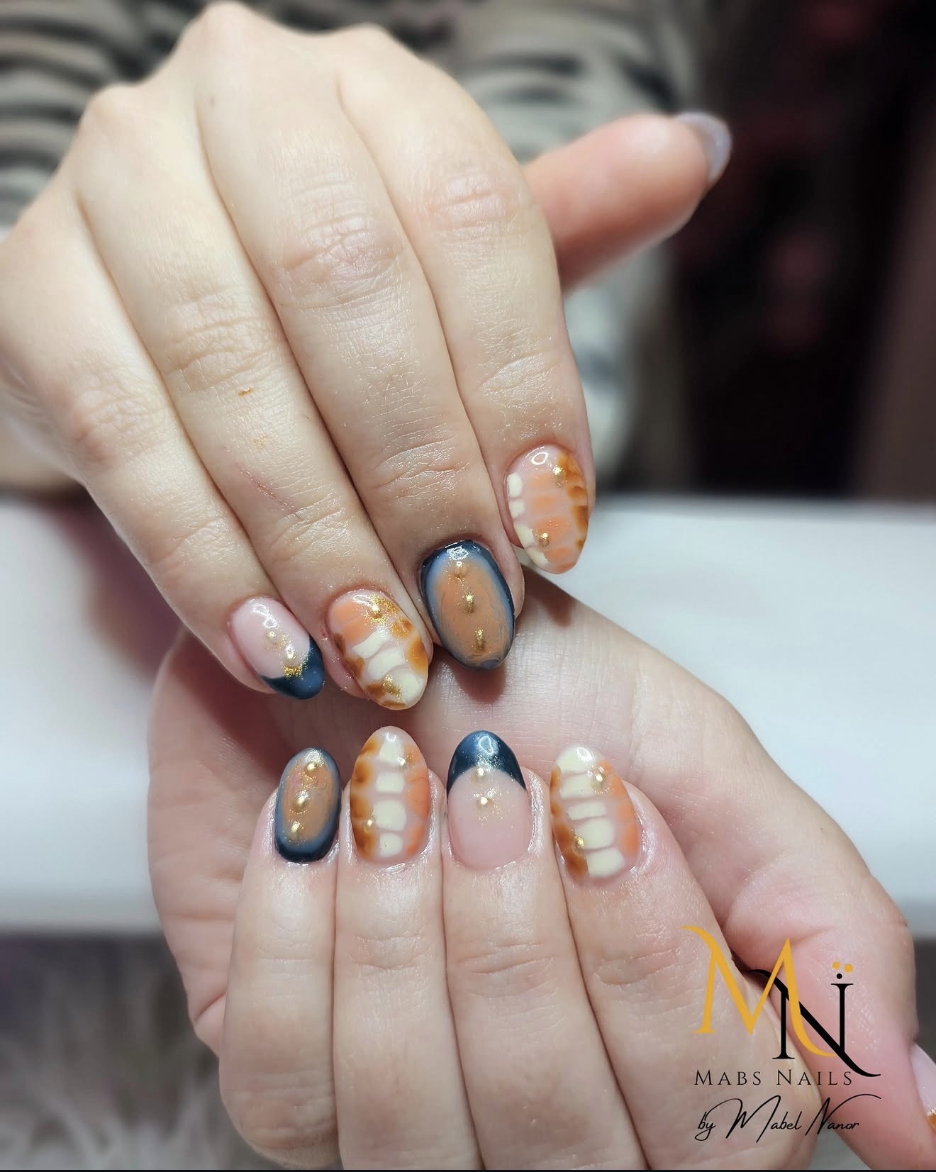 Navy and orange autumn nail design